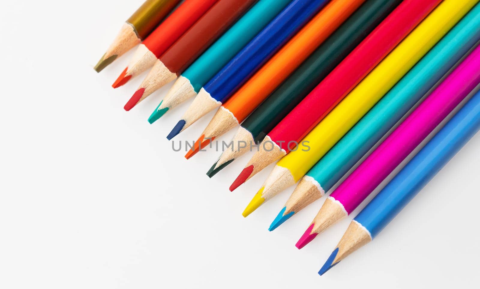 Close-up macro shot of colored pencils of a pile of pencils. Place for an inscription