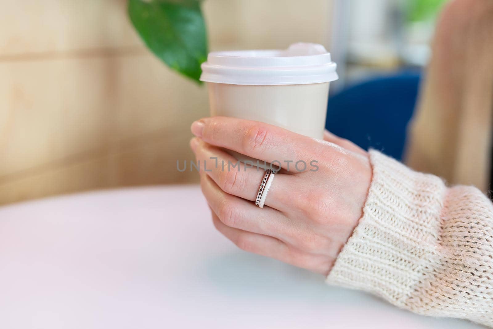 Paper coffee cup in a female hand. Coffee to go. walks in the open air