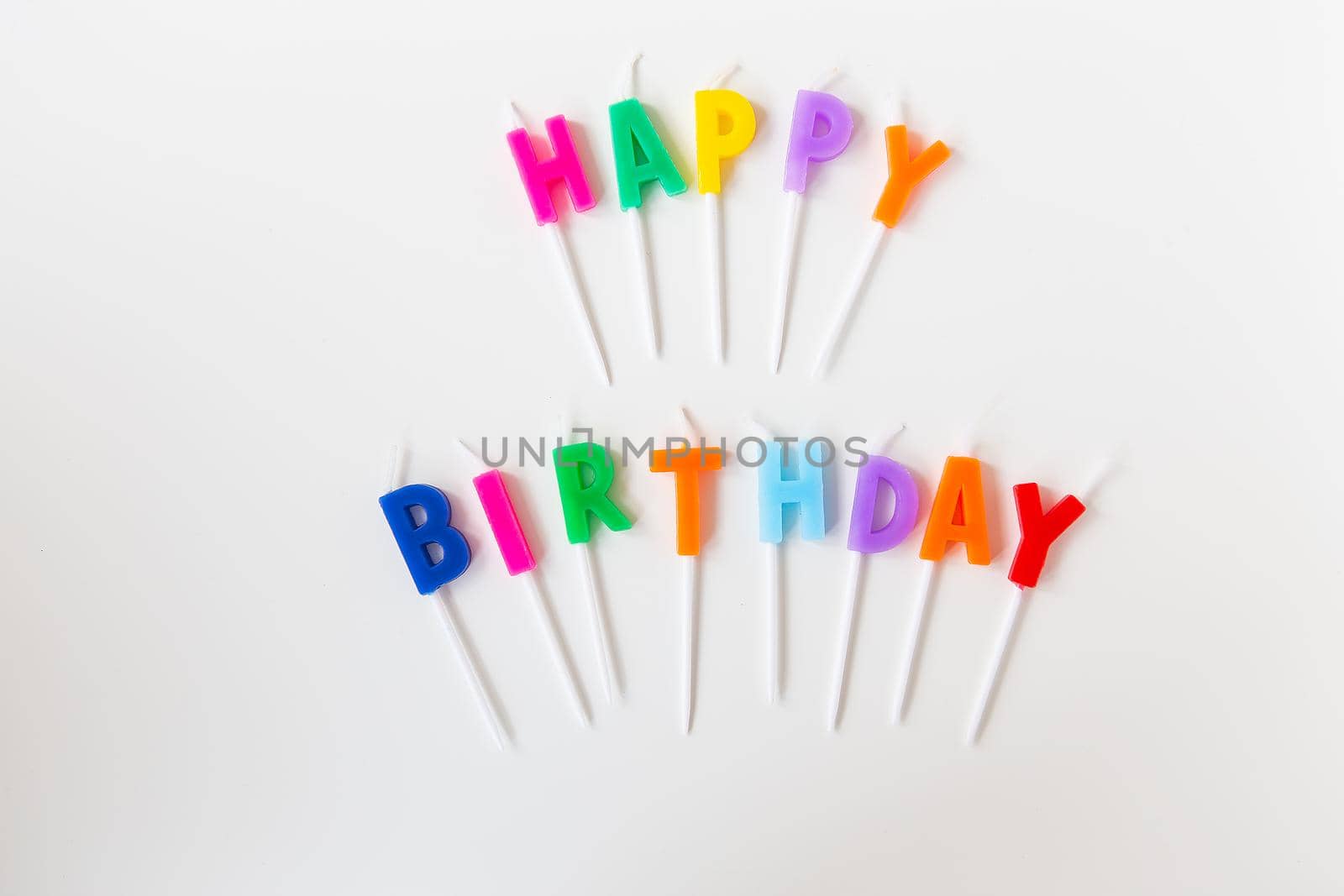 Colorful candles with the inscription Happy Birthday isolated on a white background. Holiday and surprise concept