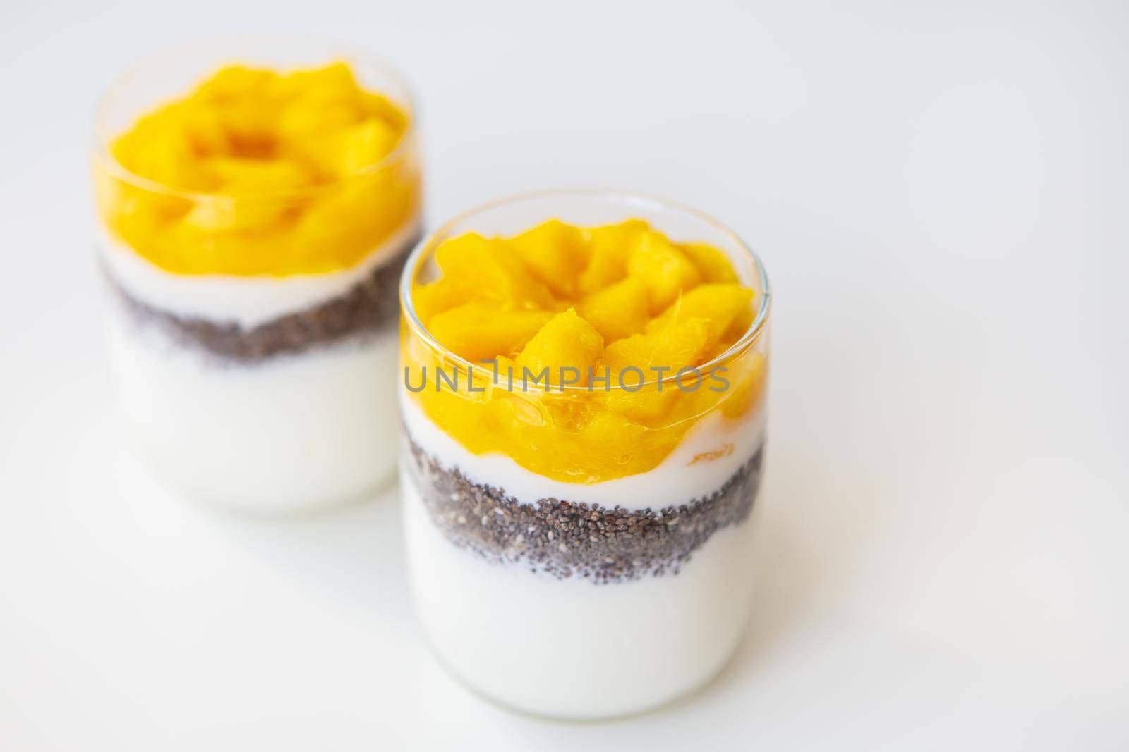 Delicious mango dessert with yogurt and chia seeds. The concept of healthy and tasty food. Good morning, lovely breakfast