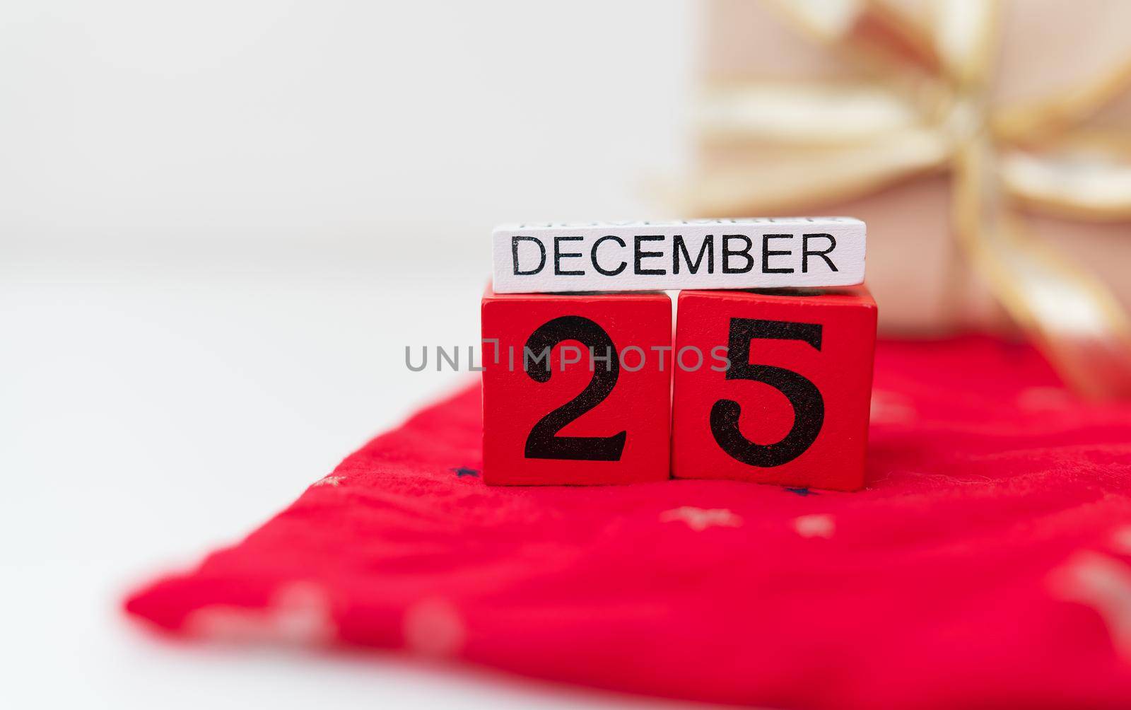 December 25 is lined with red cubes along with December lettering on a red Christmas background. Christmas Eve