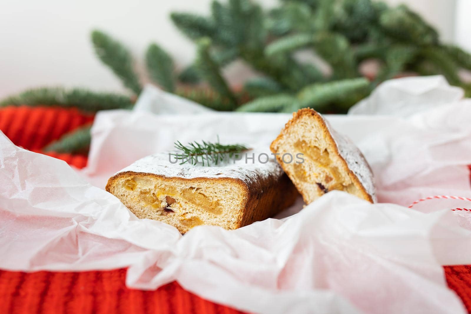 Very tasty and fragrant adit with citrus fruits, marzipan, cinnamon lies on white craft paper. New Year's and Christmas