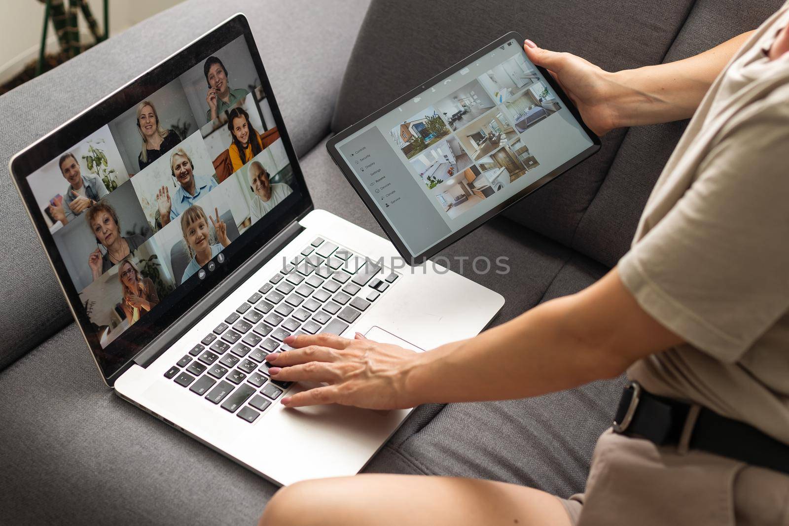 Young woman enjoying video conversation via laptop with eldery mother while sitting on sofa during self isolation for coronavirus prevention