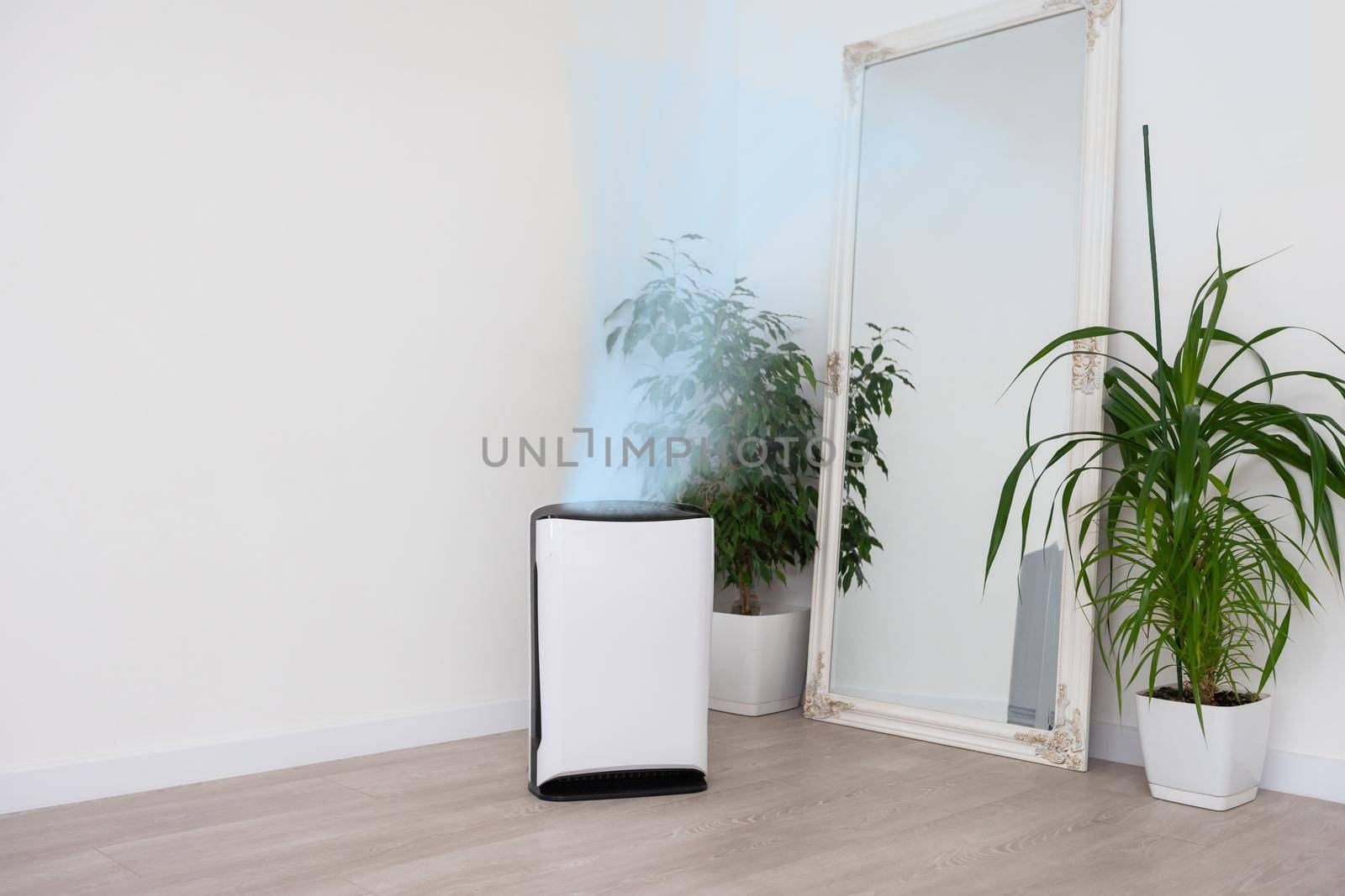 Air purifier in cozy white living room for filter and cleaning removing dust PM2.5 HEPA and virus in home, for fresh air and healthy Wellness life, Air Pollution Concept.