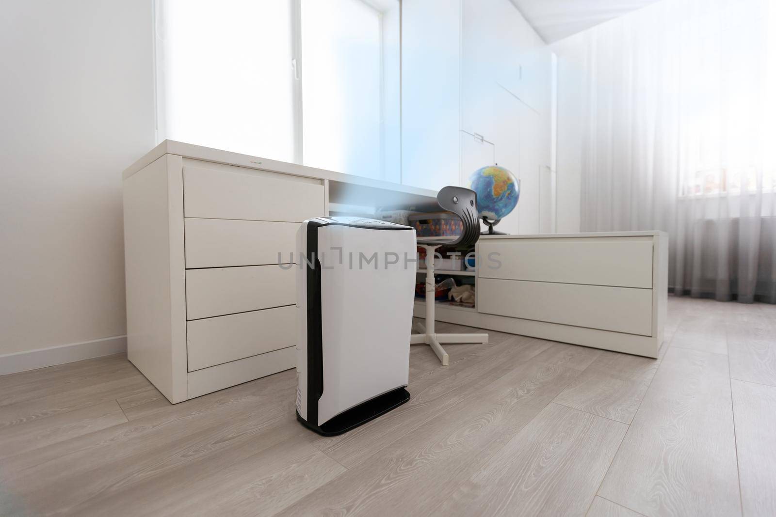 A modern humidifier in the children's bedroom. Maintaining the climate in the apartment.