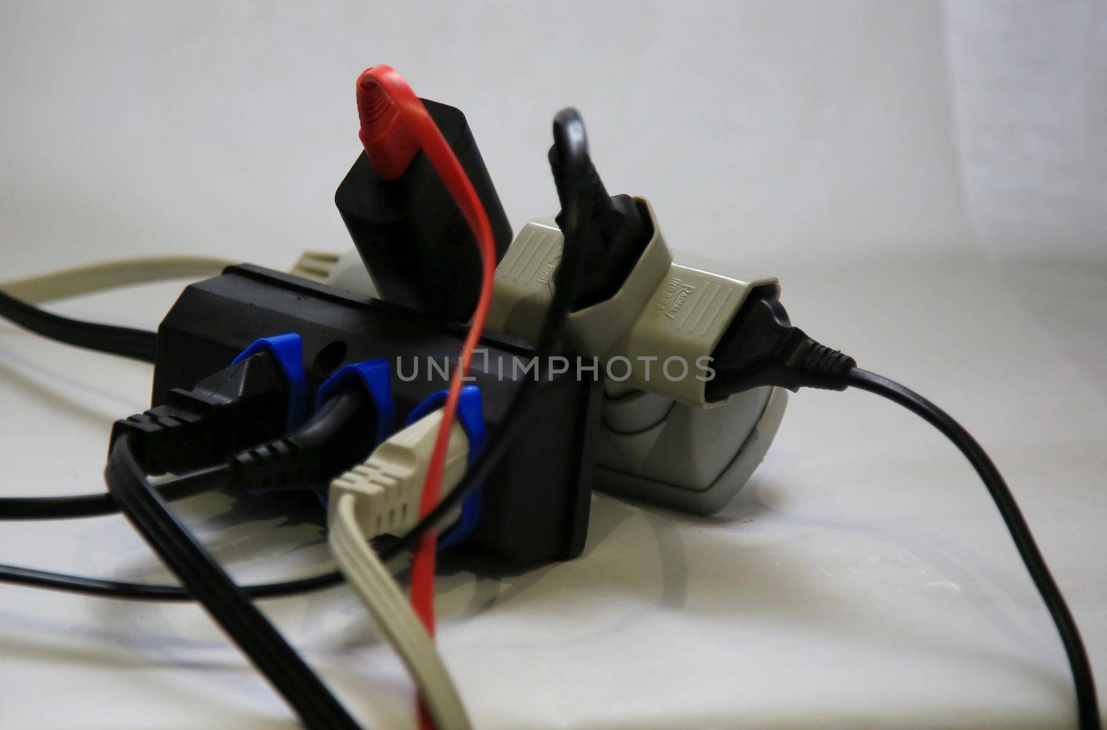 salvador, bahia / brazil - may 19, 2020: plug sockets are seen coupled to a power strip, generating an overload of electricity.
