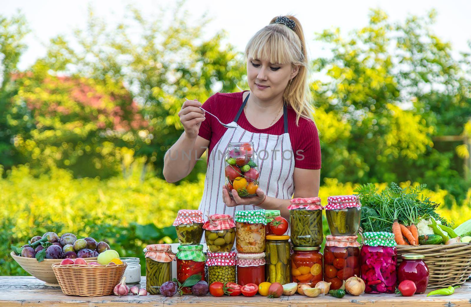 Woman with jar preserved vegetables for winter. Selective focus. Food.