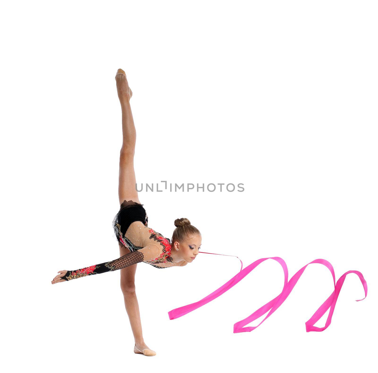 Beautiful teenager girl doing gymnastics split with ribbon