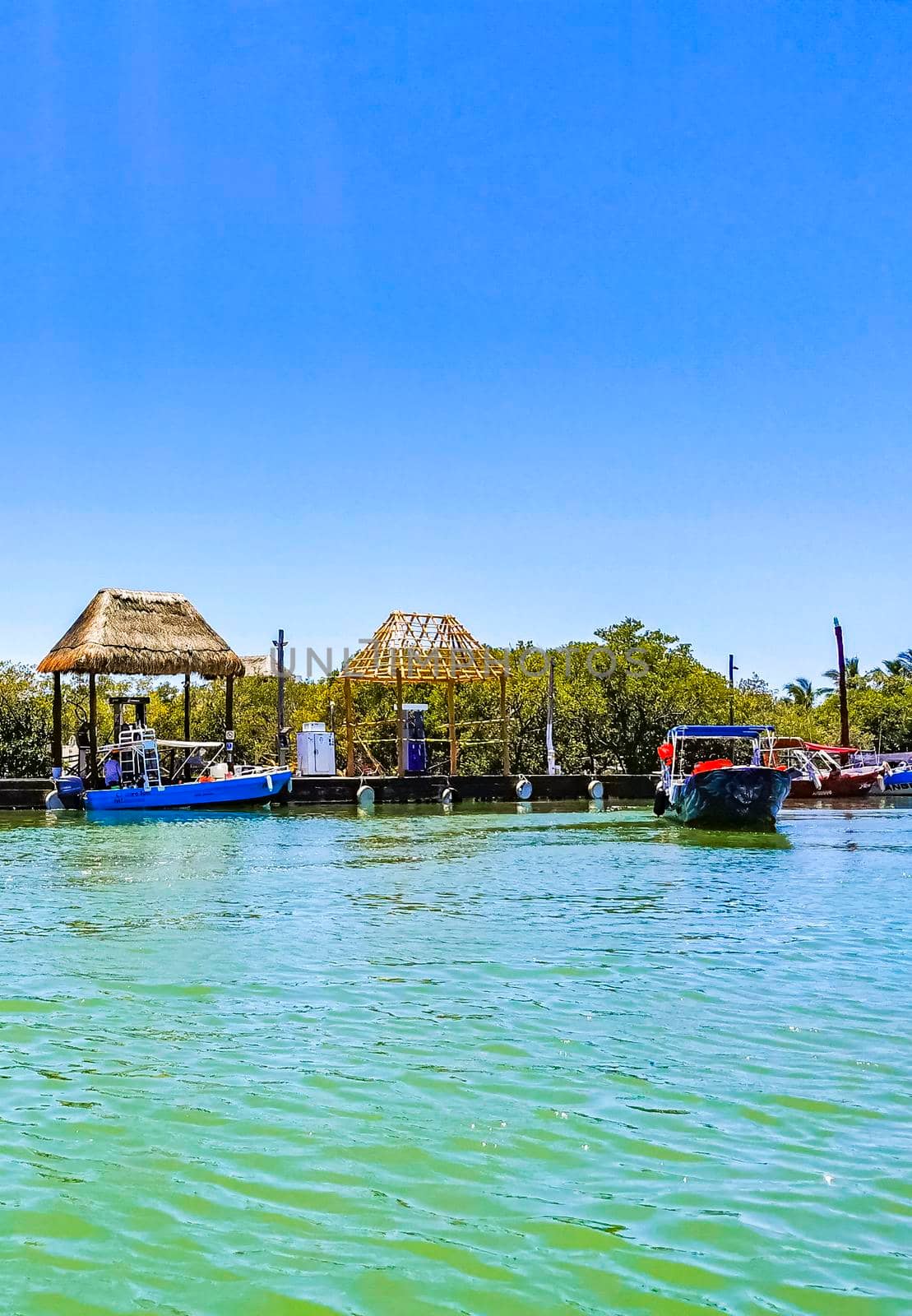 Panorama landscape Holbox boats port harbor Muelle de Holbox Mexico. by Arkadij