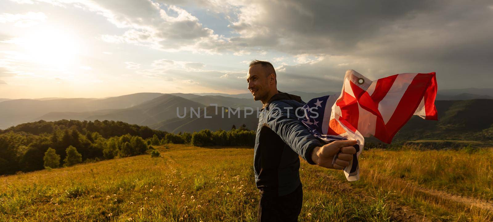 man holding an american flag.