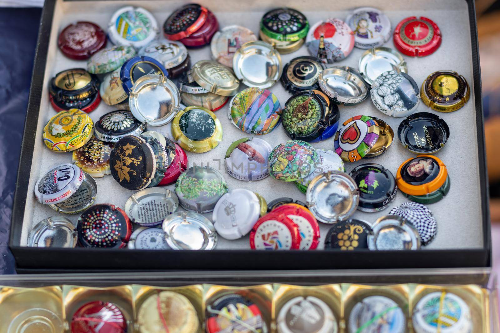 DIEPPE, FRANCE - NOVEMBER 17, 2019: Collection of champagne lids on a flea market for sale