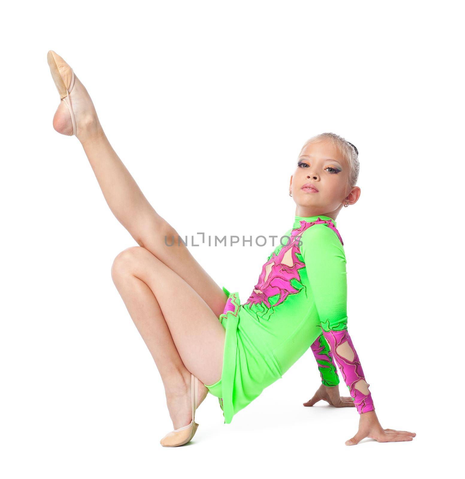 Young teenager girl doing gymnastics exercise - look at camera isolated