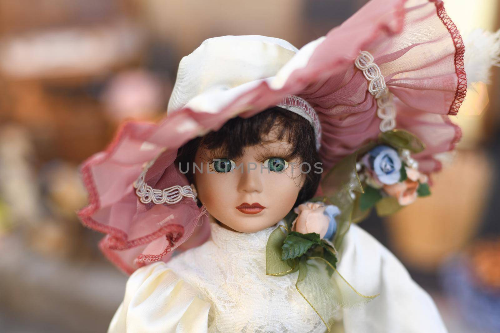 Portrait of a vintage doll in a hat at the flea market