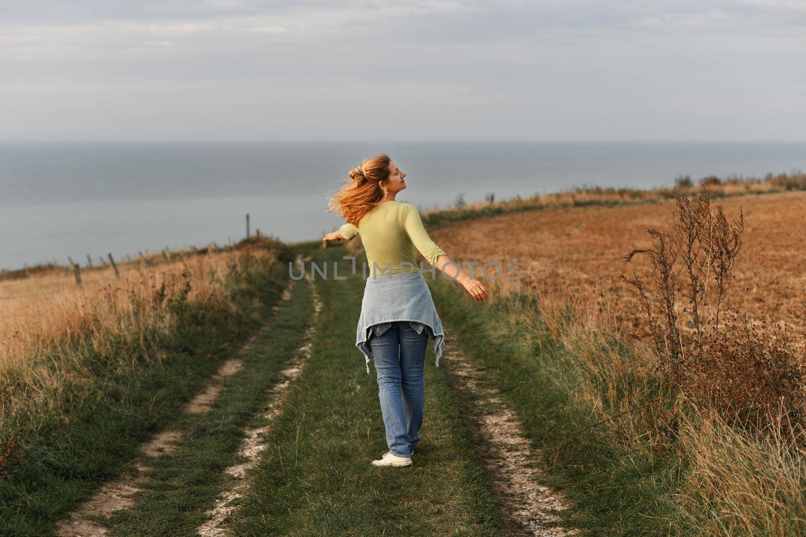 Woman whirls on and relaxes in nature near field