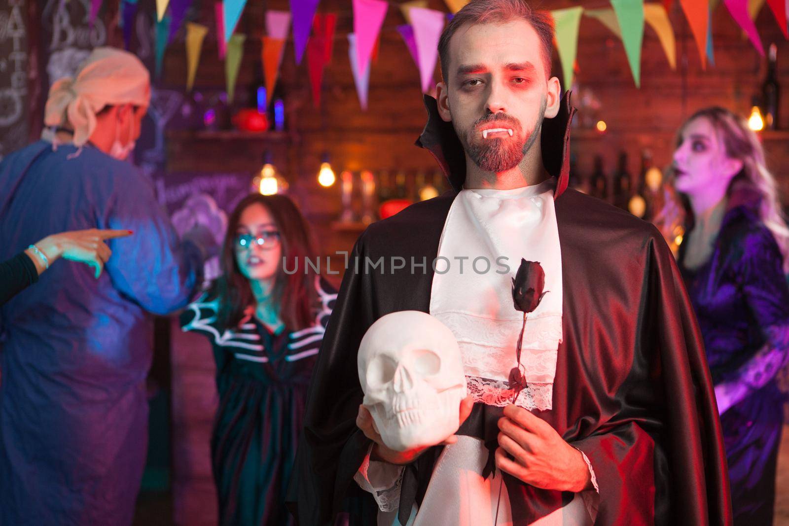 Portrait of man in dracula costume with a serious face for halloween party by DCStudio