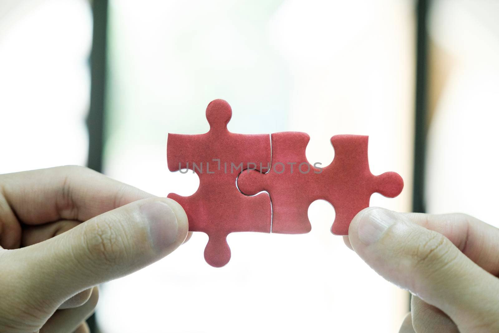 Close up of business people assemble jigsaw puzzle find perfect match. by ijeab