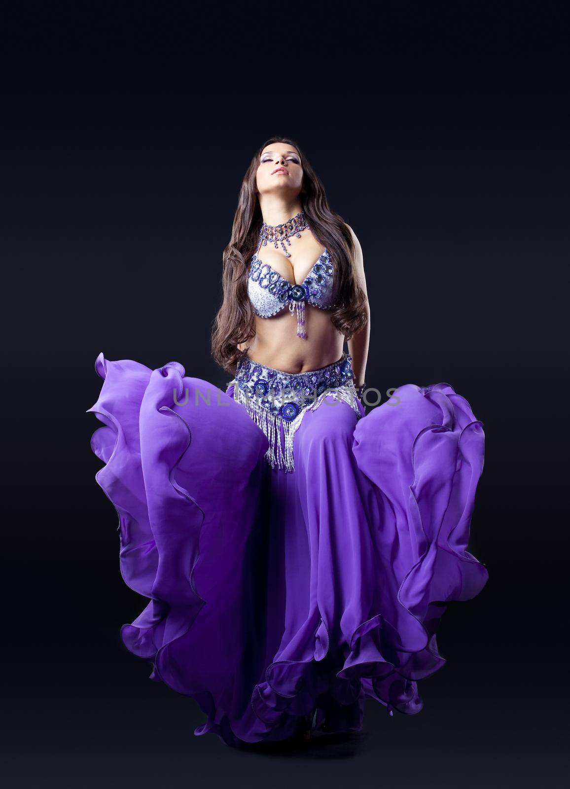 beautiful girl dance in dark with oriental flying purple cloth