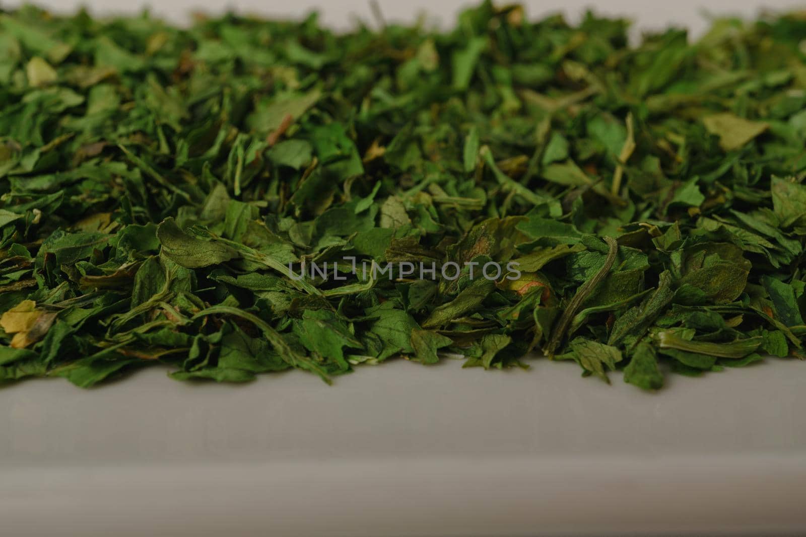 dried parsley on a white plate by joseantona