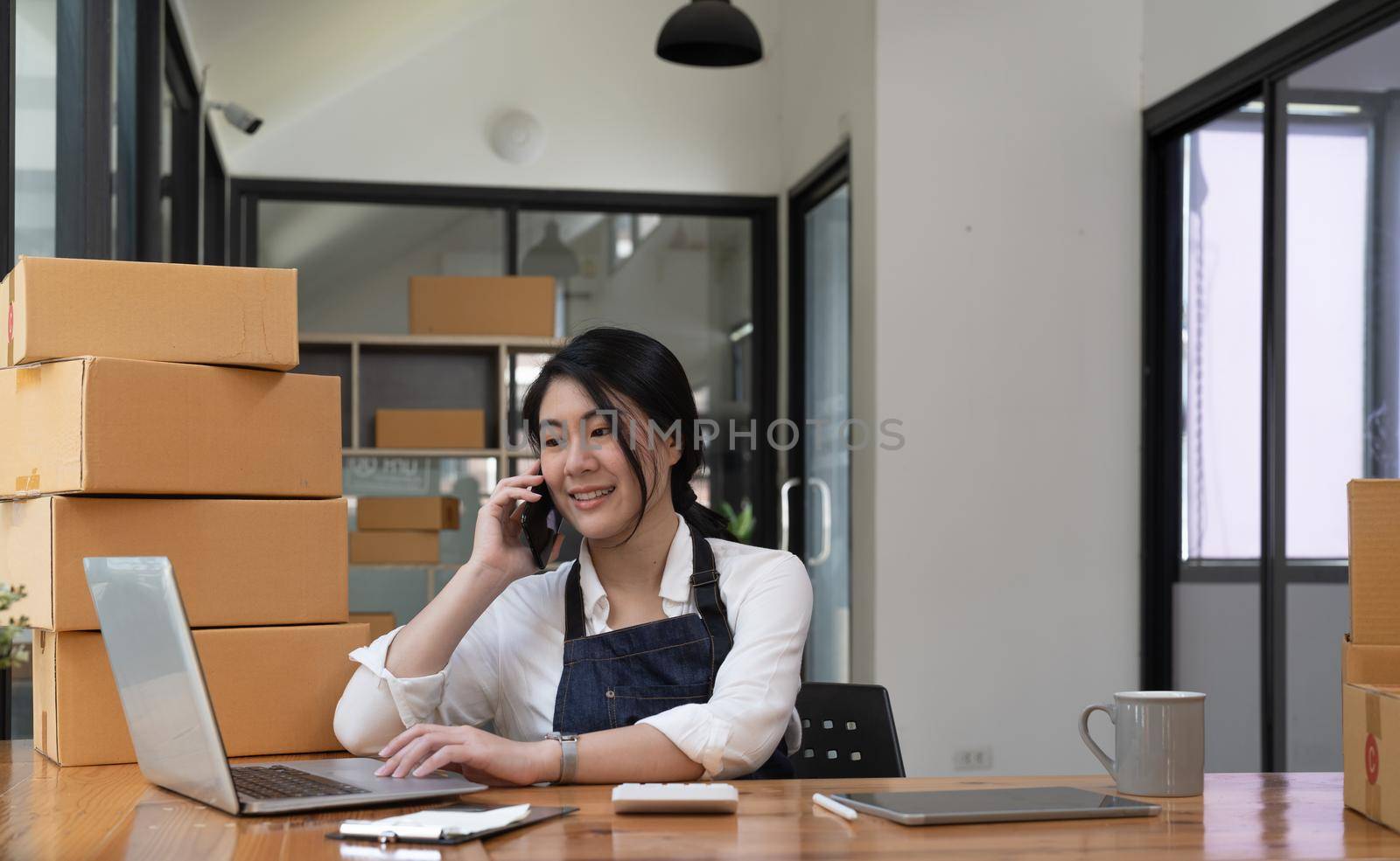 Online business owner are taking on the phone orders for customers, negotiating for delivery.