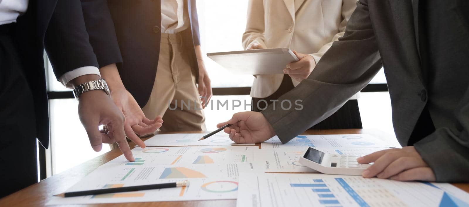 Asian business adviser meeting to analyze and discuss the situation on the financial report in the meeting room.Investment Consultant,Financial Consultant,Financial advisor and accounting concept by wichayada