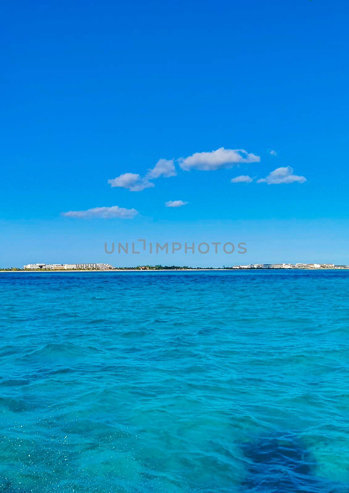 Boat trip tour from Cancun to Island Mujeres Isla Contoy and Whale shark tour with natural tropical seascape panorama and blue turquoise and green clear water view from boat in Quintana Roo Mexico.