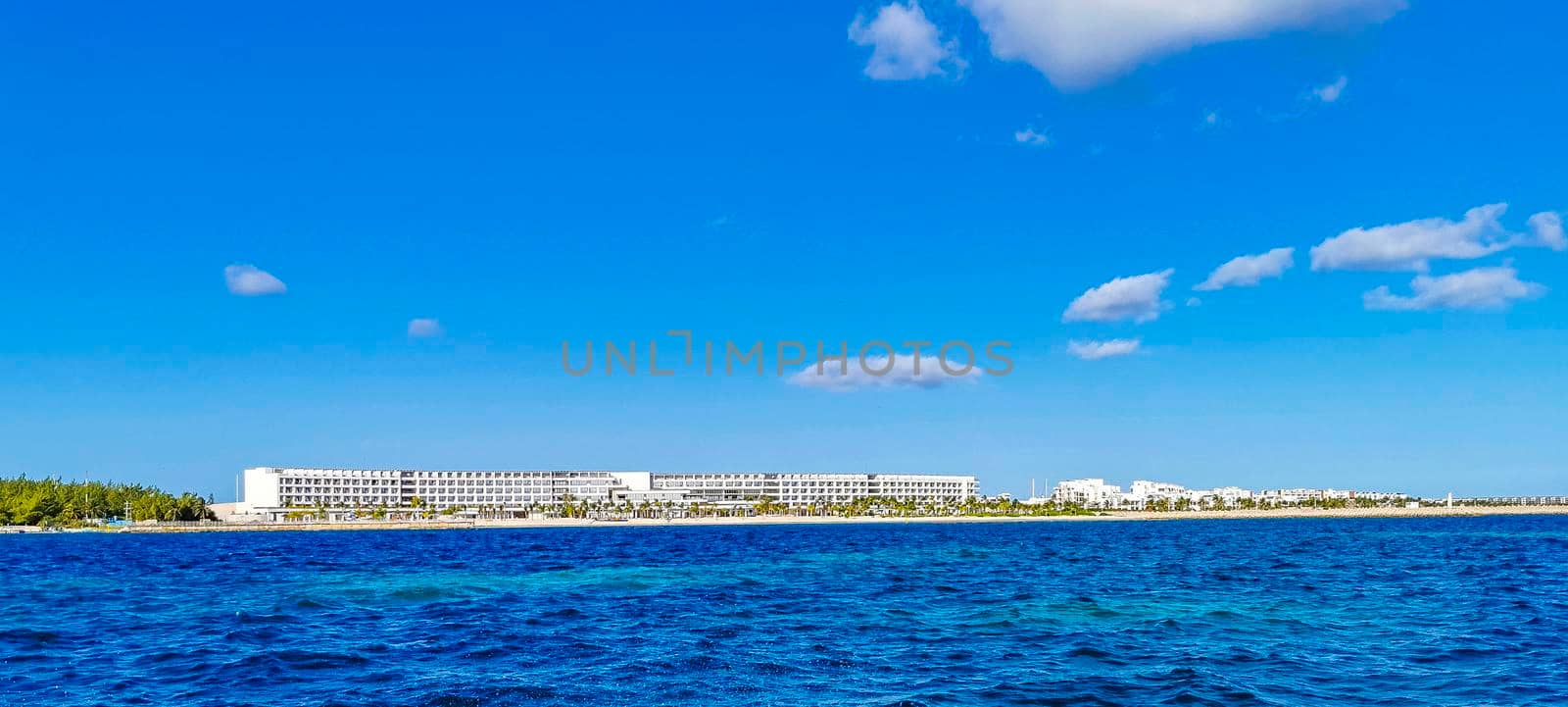 Beautiful Playa Azul beach and seascape panorama with blue turquoise water hotels resorts and palm trees in Cancun Quintana Roo Mexico.