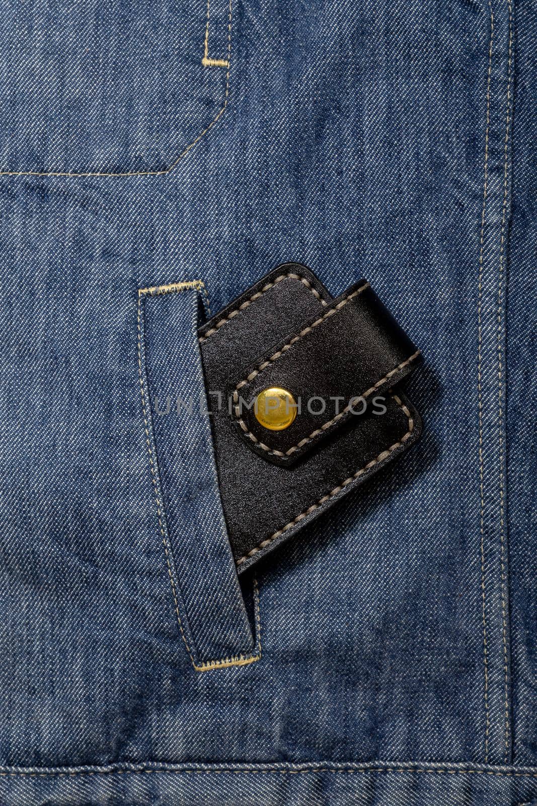 Luxury craft business card holder case made of leather. Black Leather box for cards in a pocket of jeans jacket.