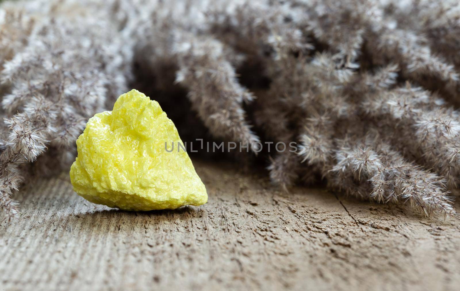 Native sulfur crystal closeup on wooden background by Syvanych