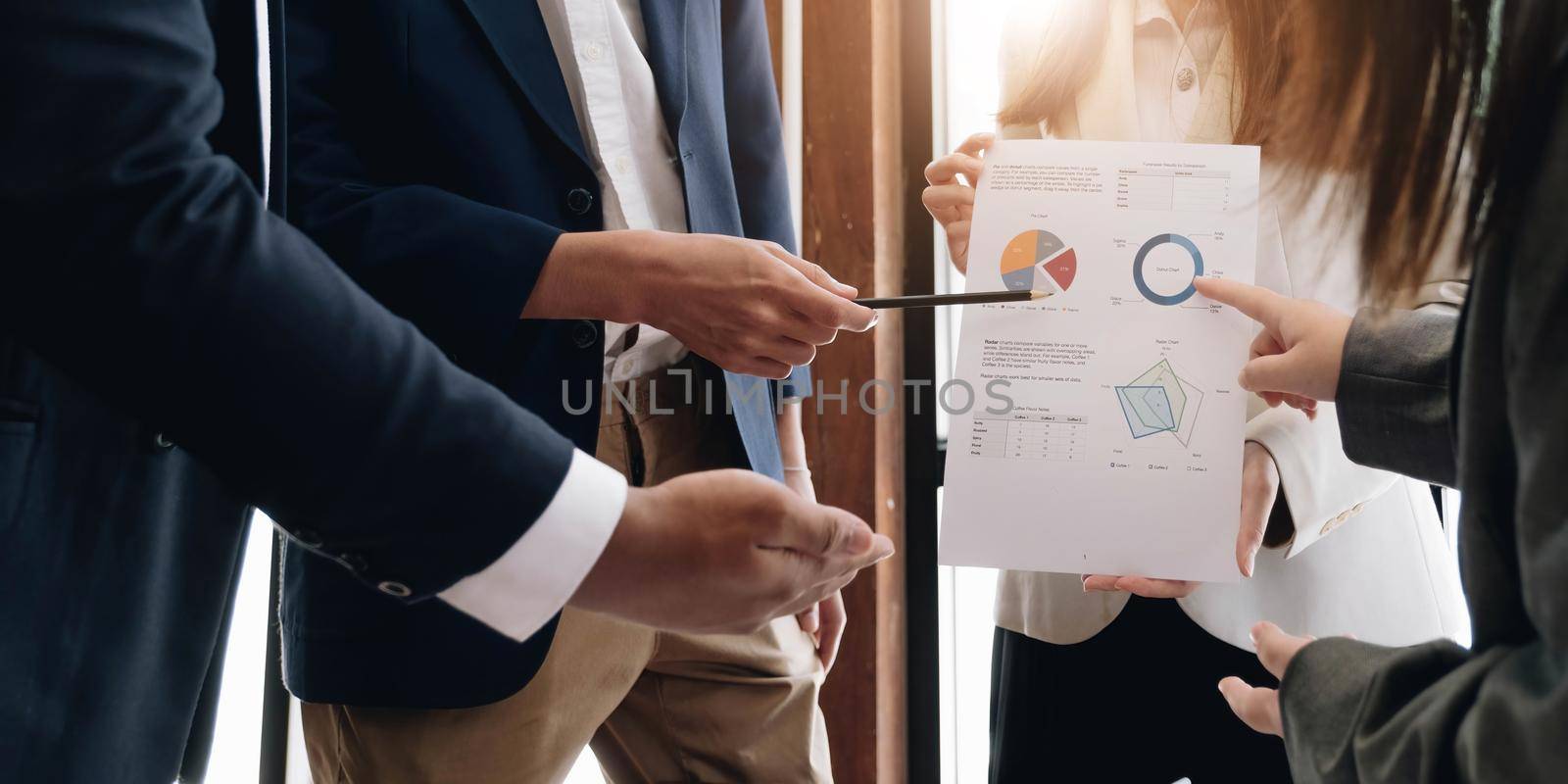Business people hand pointing at business document during discussion at meeting..
