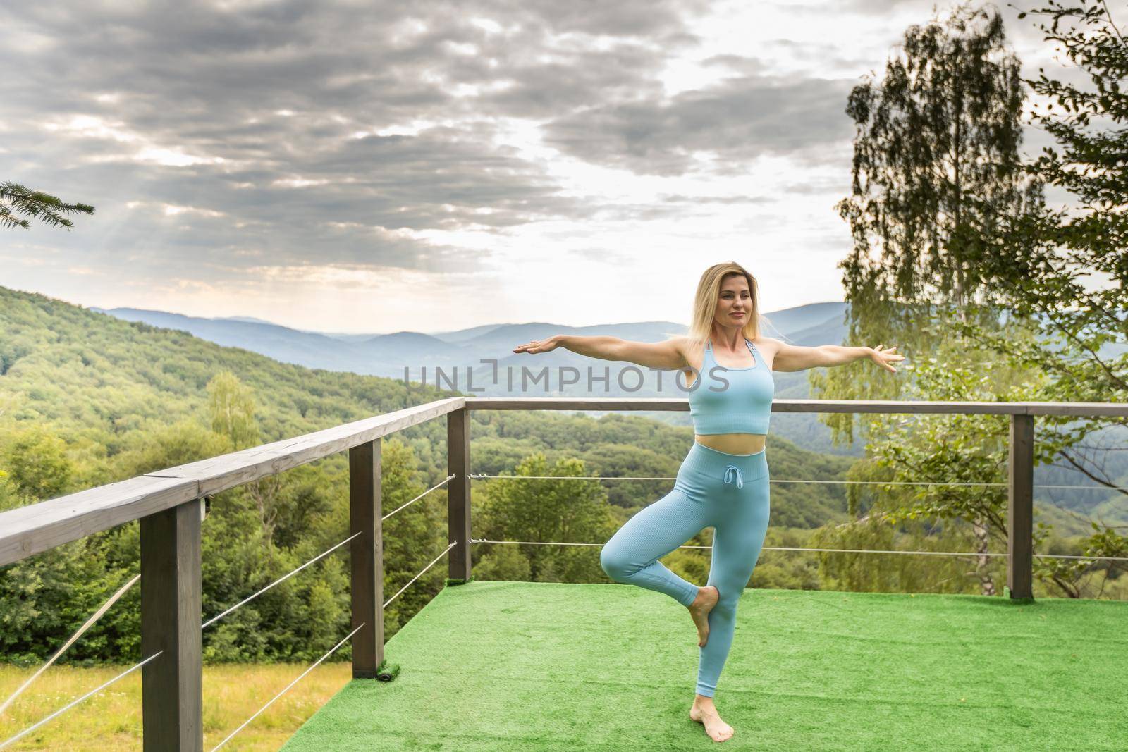 a woman does yoga on the terrace.
