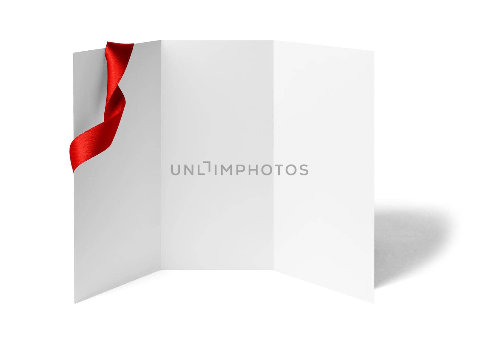 close up of a note card or leaflet brochure with ribbon bow on white background