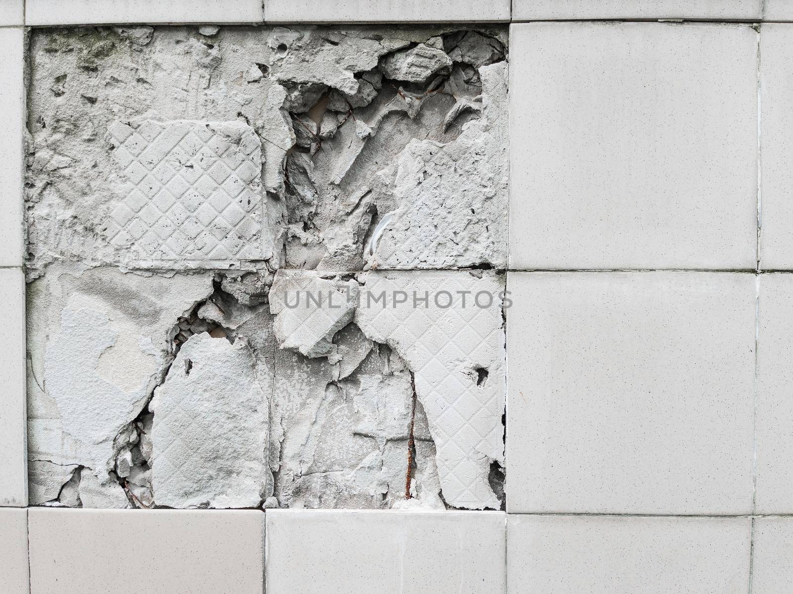 A wall with a broken off gray tile from the wall by AlexGrec