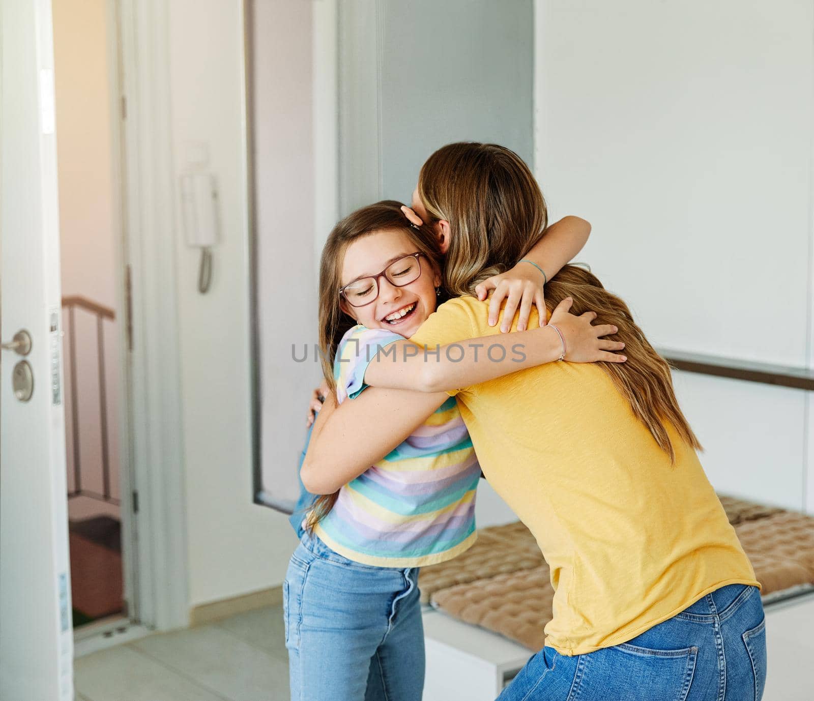 Portriat of a young teen school girl with backpack welcomed by her mother after coming back from school at home