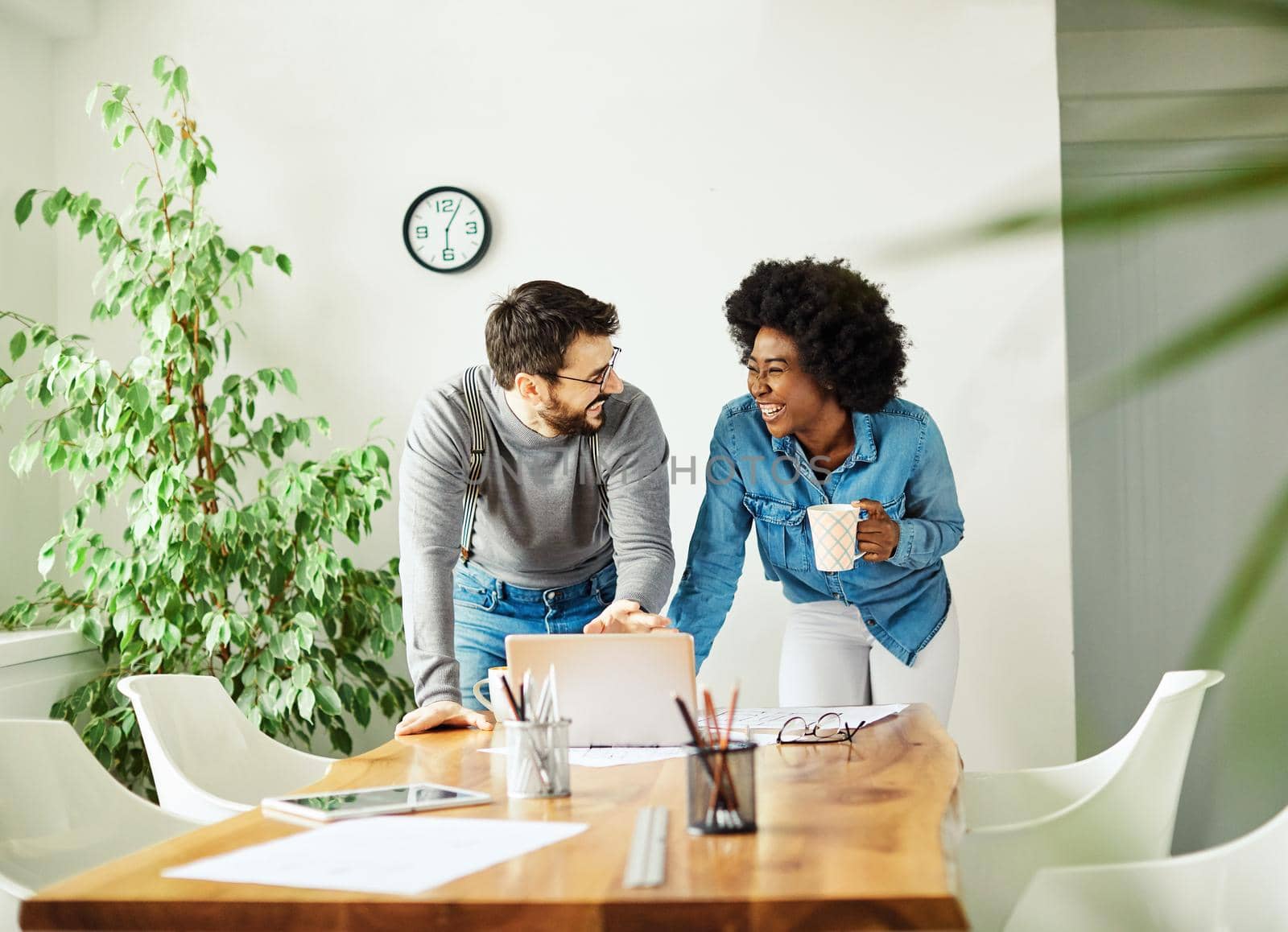 Portrait of two young business people having a meeting in the office. Teamwork and success concept