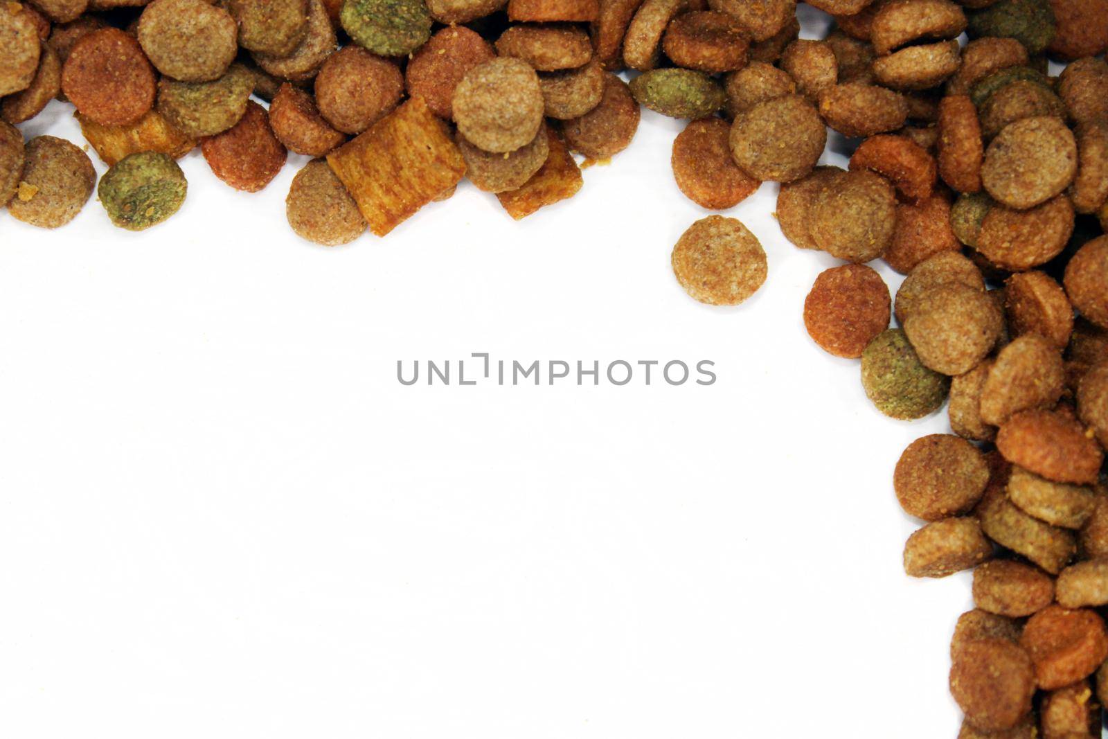 Dry food for cats, dogs is laid out in the form of a frame on a light background with a copy space. Close-up.