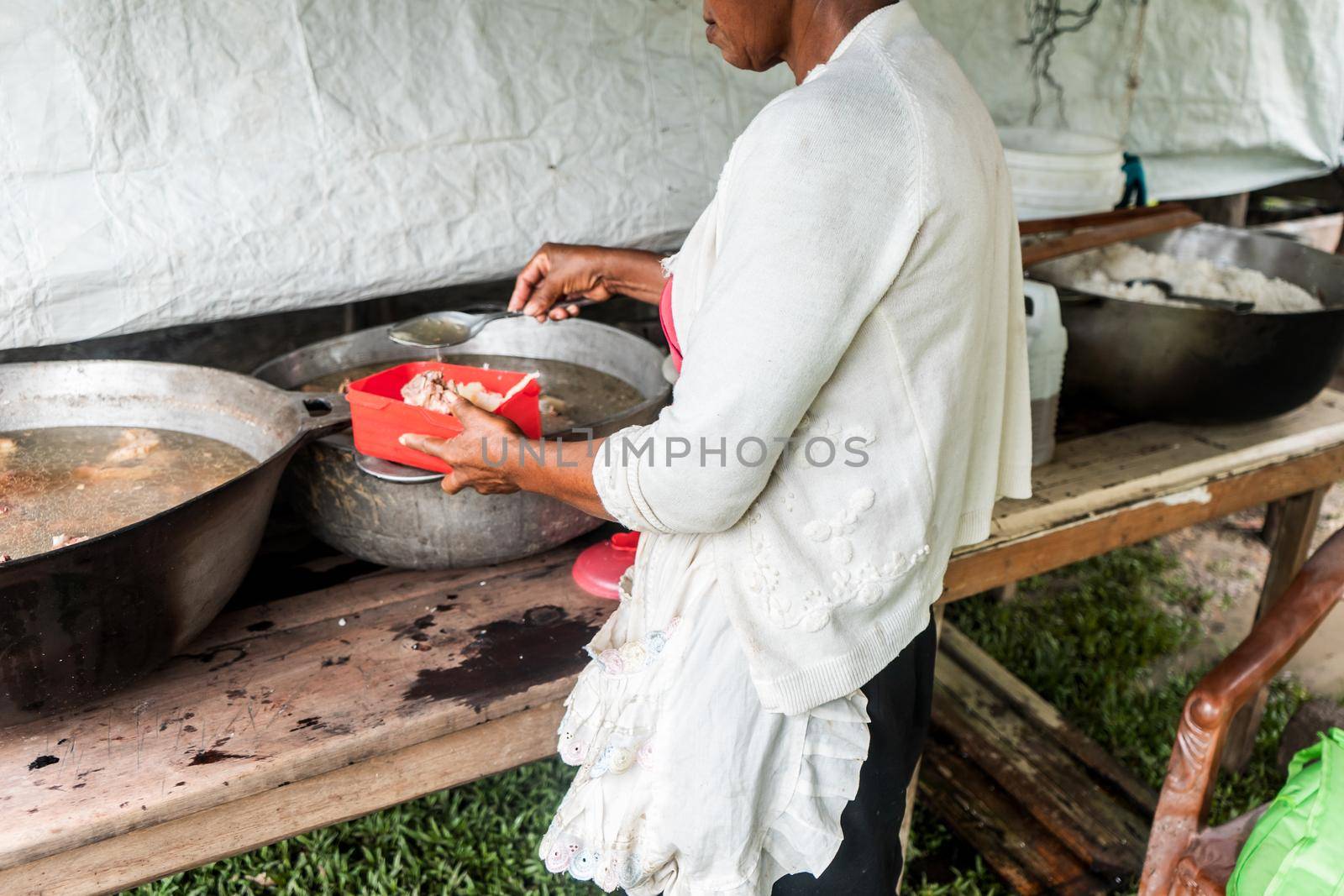 Unrecognizable indigenous woman cooking in her humble home on the Caribbean coast of Nicaragua, Central America