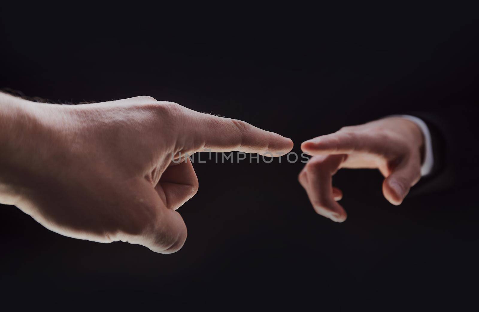 Hands isolated on black background with index finger extended by Prosto