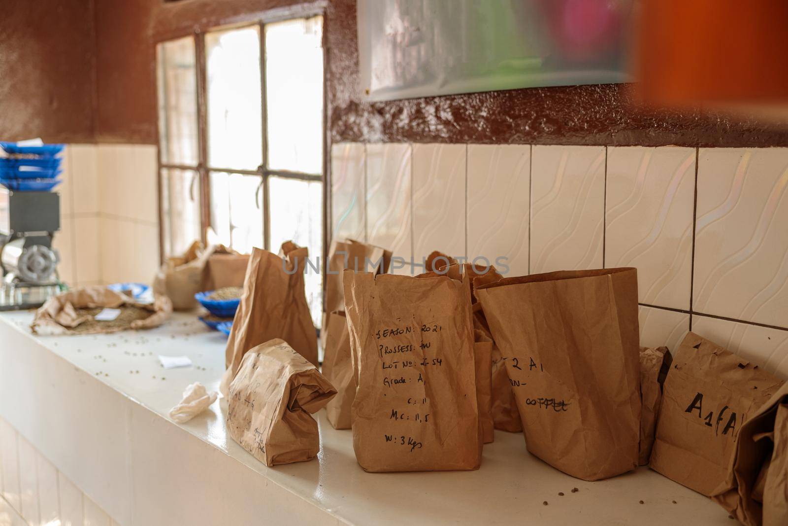 Paper bags filled with freshly baked roasted coffee to preserve its aroma on table