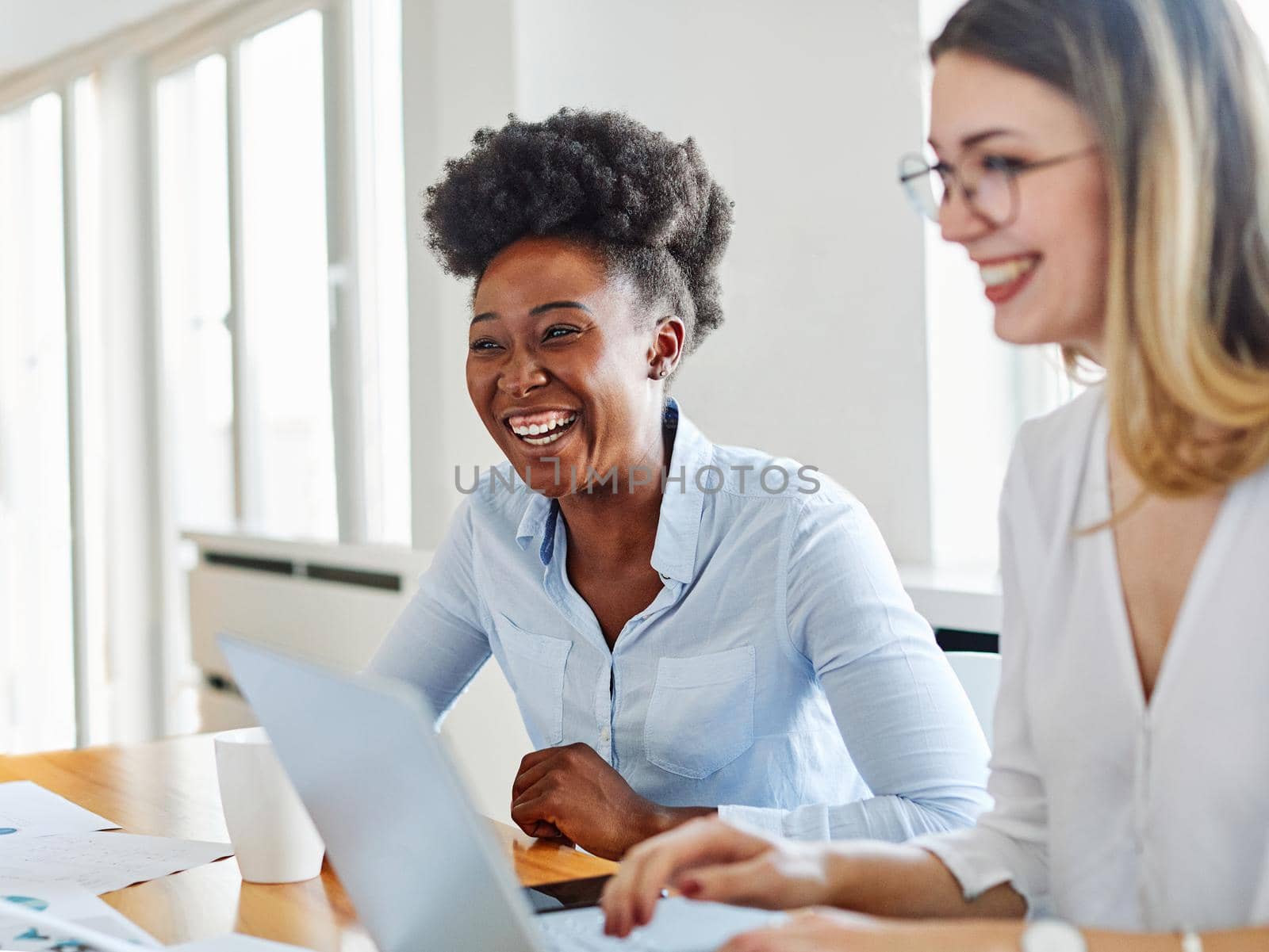 Portrait of young african american businesswoman in the office or in school education with friends laughing and using laptop