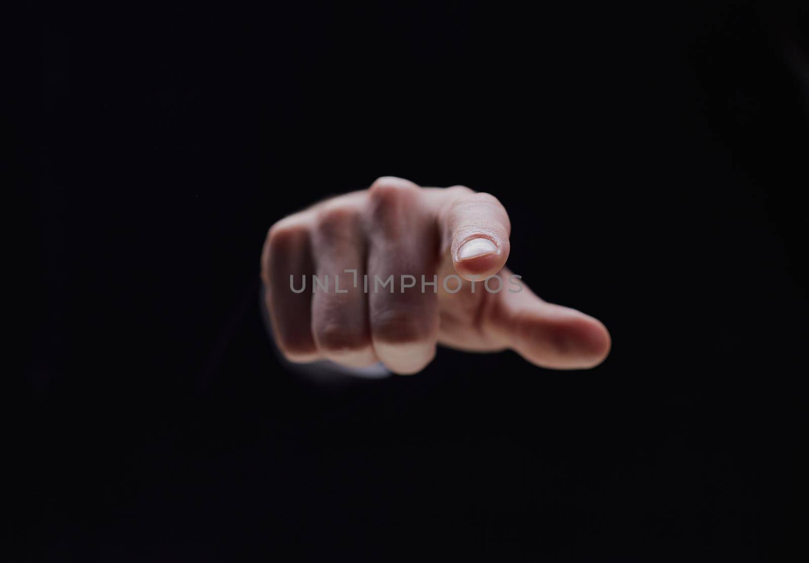 Hand isolated on black background with index finger extended by Prosto