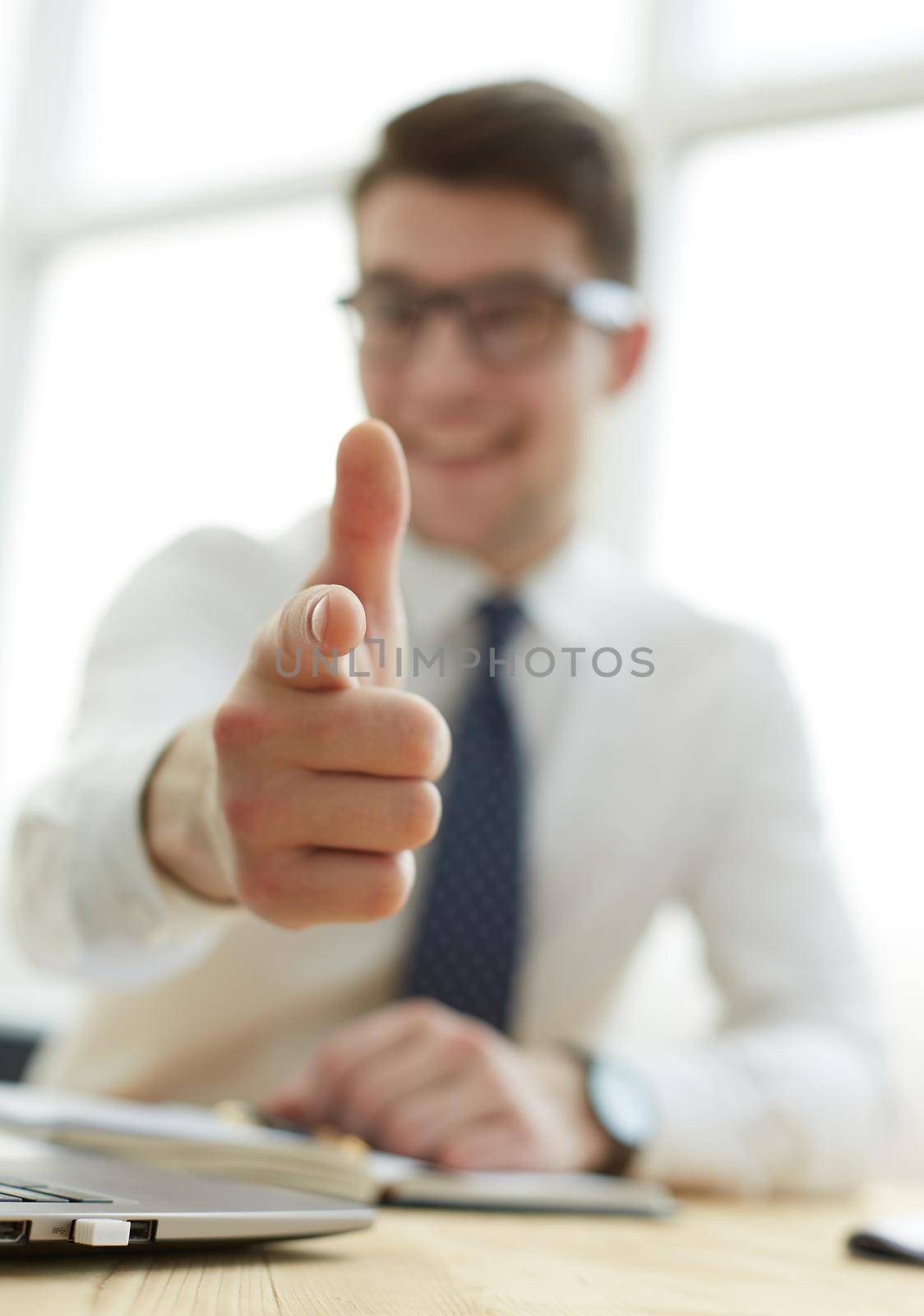 Handsome smiling businessman pointing his finger to you by Prosto