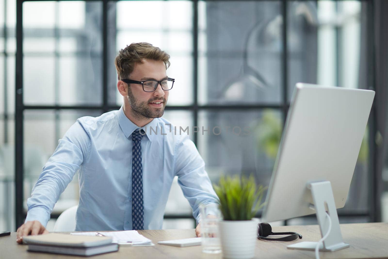 Young businessman working at office by Prosto