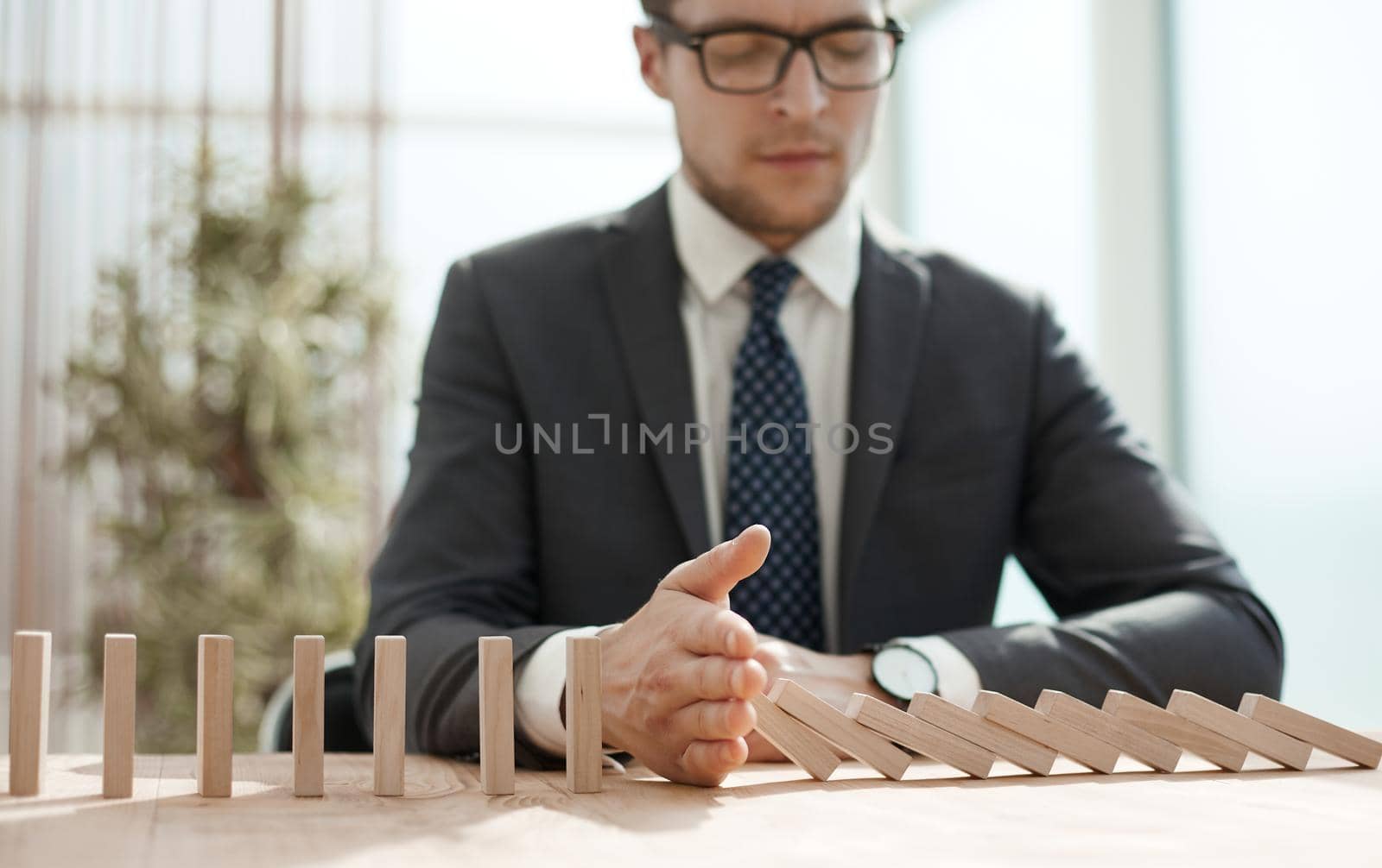 Businessman with dominoes in the office. concept business risk by Prosto