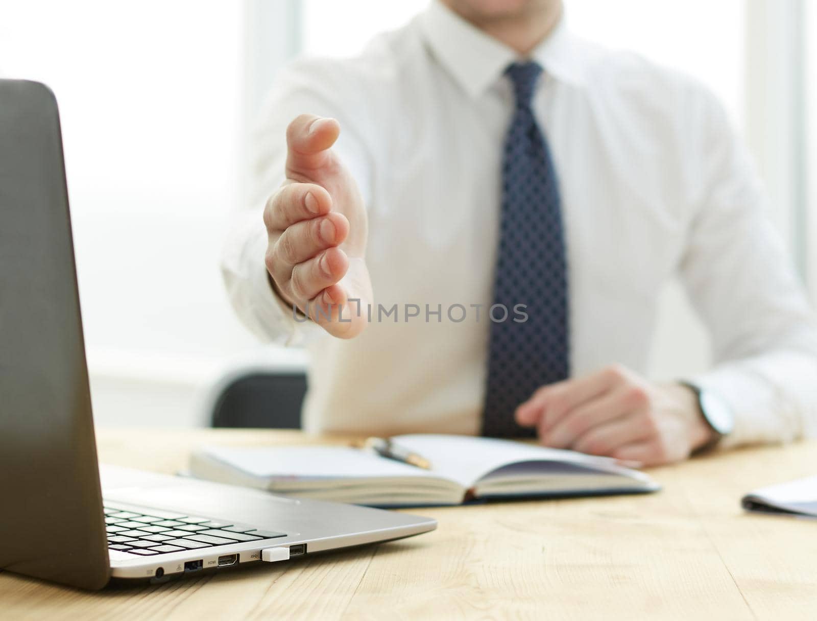 Smiling businessman pleased to meet you at office