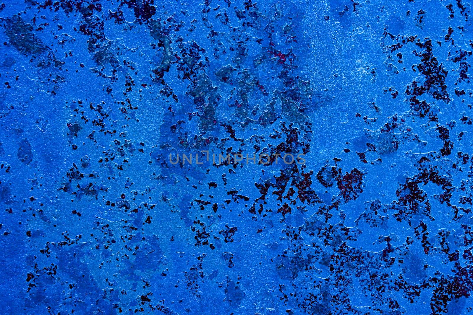 Abstract blue texture of an old wall with paint cracks. Design background with place for text.