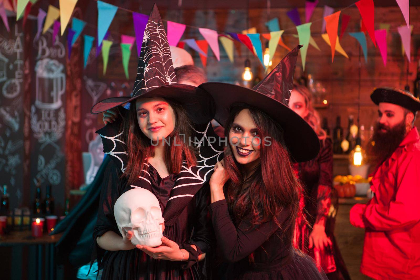 Portrait of excited young witches for halloween party. Beautiful witches.