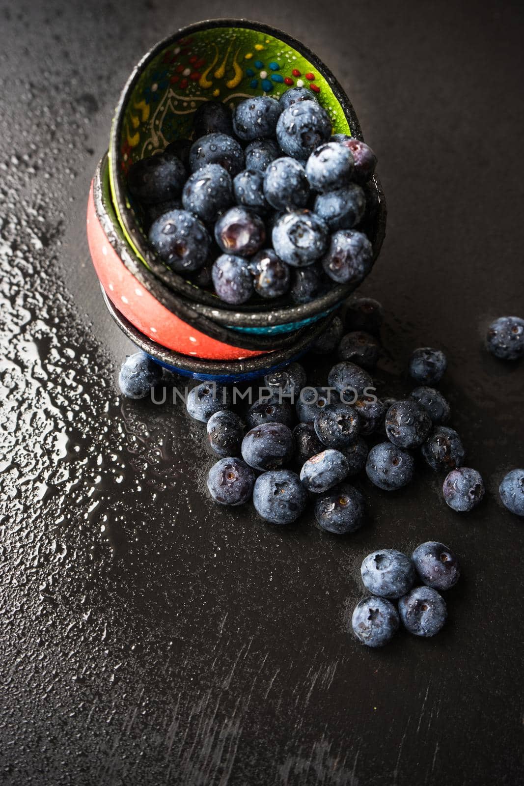 Ripe organic bilberries on dark wooden table with copyspace as a organic food concept