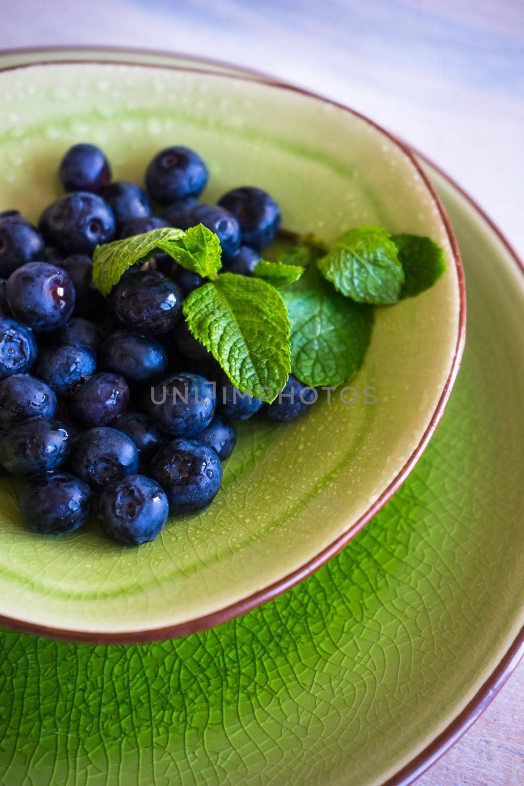 Ripe organic bilberries on dark wooden table with copyspace as a organic food concept