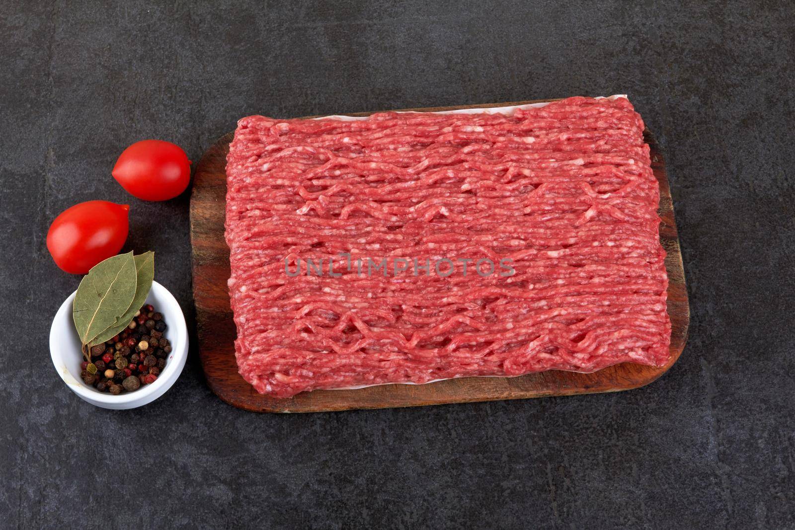Fresh pork and beef minced meat on a black