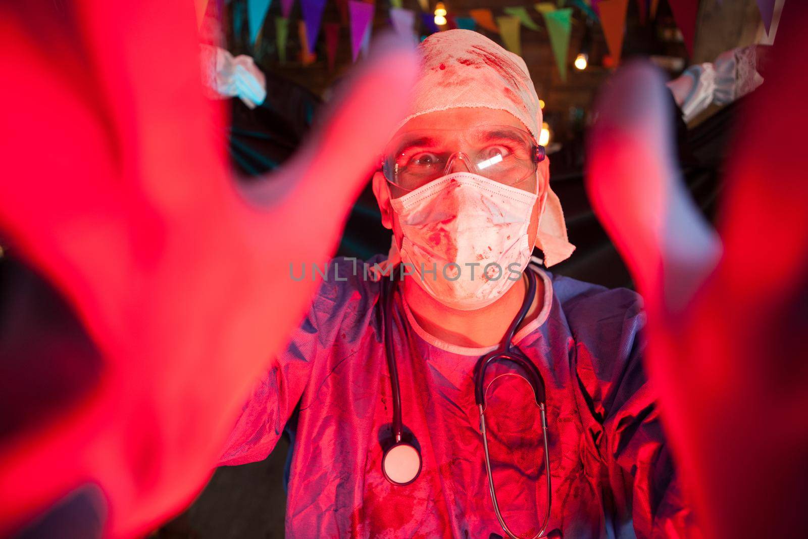Excited hansome man dressed up like a creepy doctor at halloween party by DCStudio